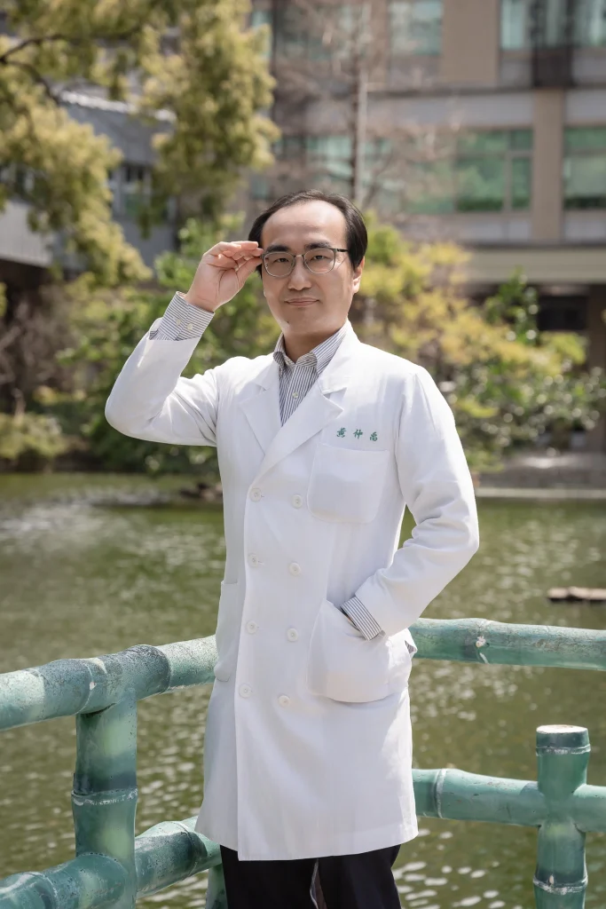 0317 0024 白袍醫師專業形象照,醫師手扶眼鏡站在戶外欄杆旁